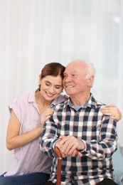 Photo of Elderly man with female caregiver at home