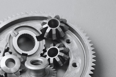 Photo of Different stainless steel gears on light grey background