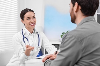 Doctor consulting patient during appointment in clinic