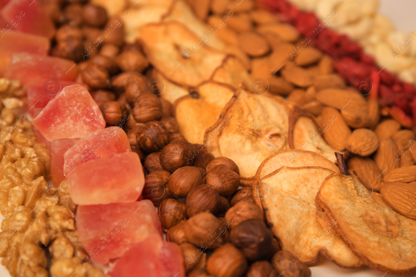 Photo of Mix of delicious dried nuts and fruits, closeup