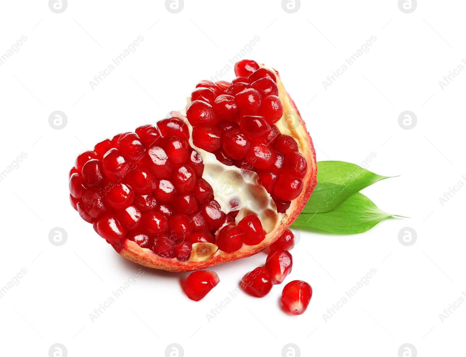 Photo of Ripe pomegranate with juicy seeds and leaves on white background