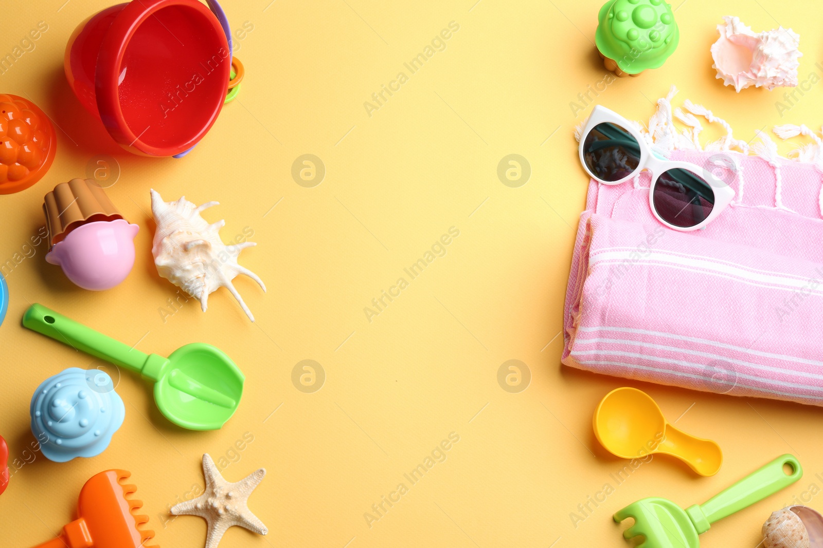 Photo of Flat lay composition with bright beach toys on color background. Space for text