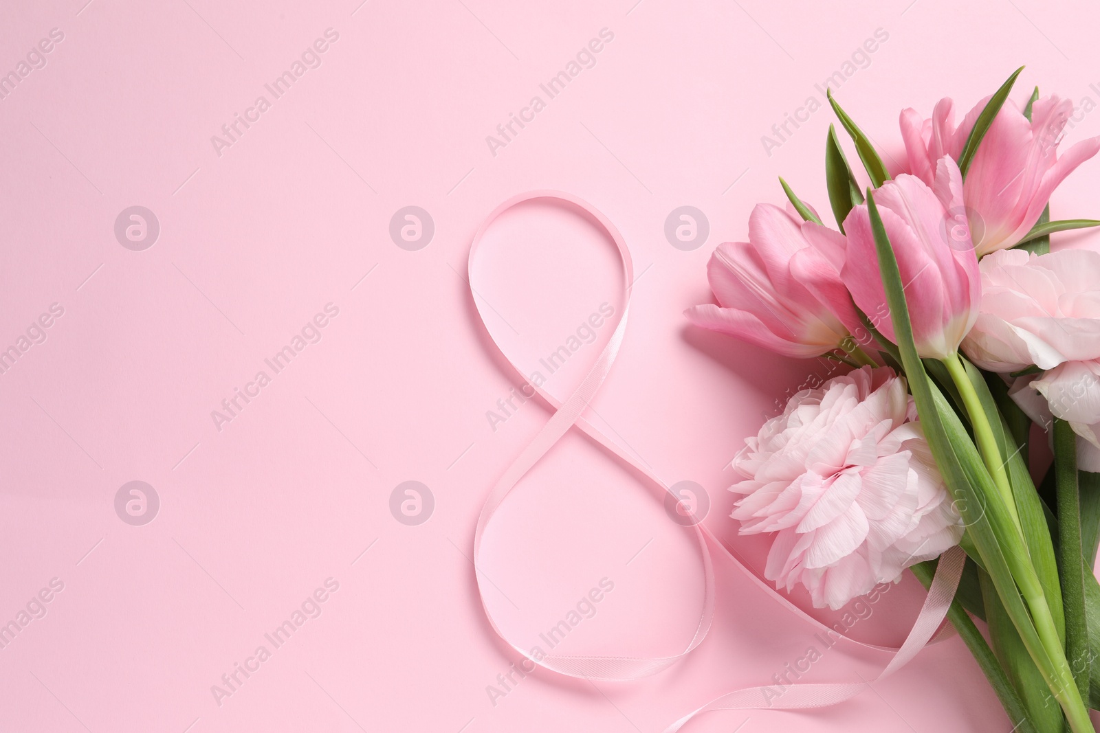 Photo of 8th of March greeting card design with ribbon, beautiful flowers and space for text on pink background, flat lay. International Women's day