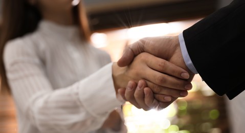 Image of Business partners shaking hands after meeting in office, closeup. Banner design
