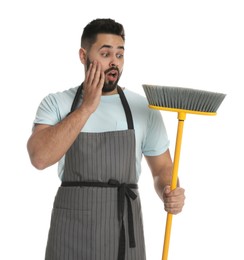 Photo of Emotional young man with yellow broom on white background