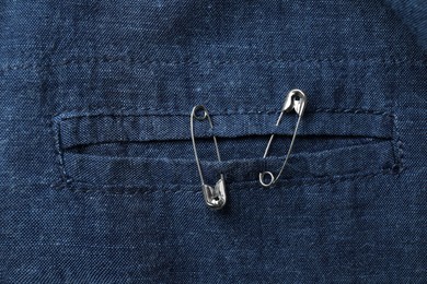 Top view of metal safety pins on clothing