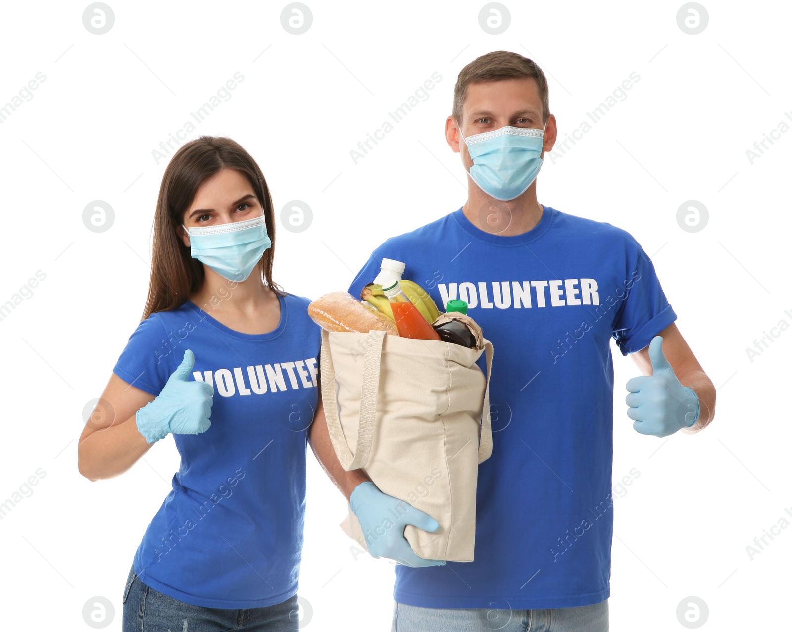 Photo of Volunteers in protective masks and gloves with products on white background. Aid during coronavirus quarantine