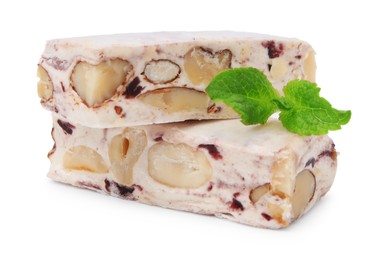 Photo of Pieces of delicious nougat and mint on white background