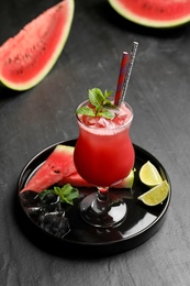 Tasty watermelon drink with mint on black table