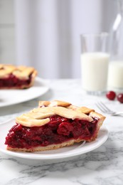 Photo of Slice of delicious fresh cherry pie on white marble table