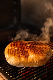 Baking pita bread on grilling grate in oven