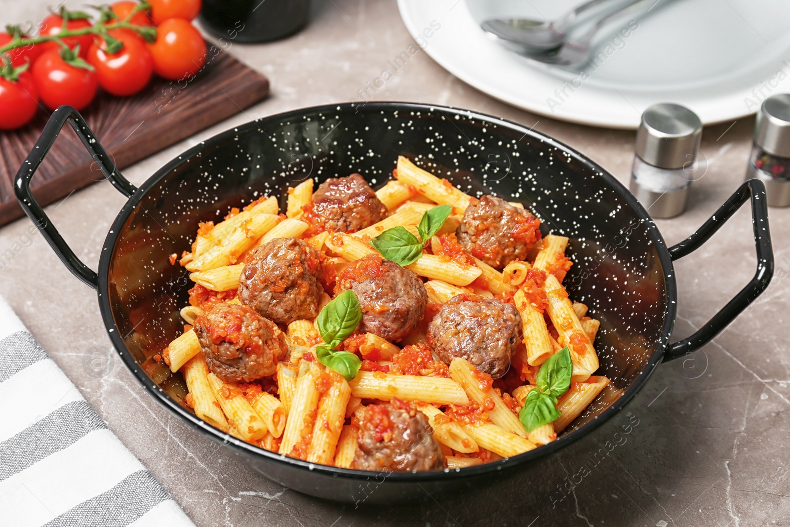 Photo of Pasta with meatballs and tomato sauce on grey background