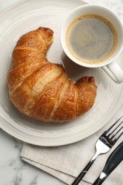 Photo of Delicious fresh croissant served with coffee on table, flat lay