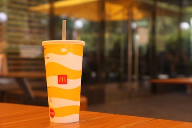 MYKOLAIV, UKRAINE - AUGUST 11, 2021: Cold McDonald's drink on table in cafe. Space for text