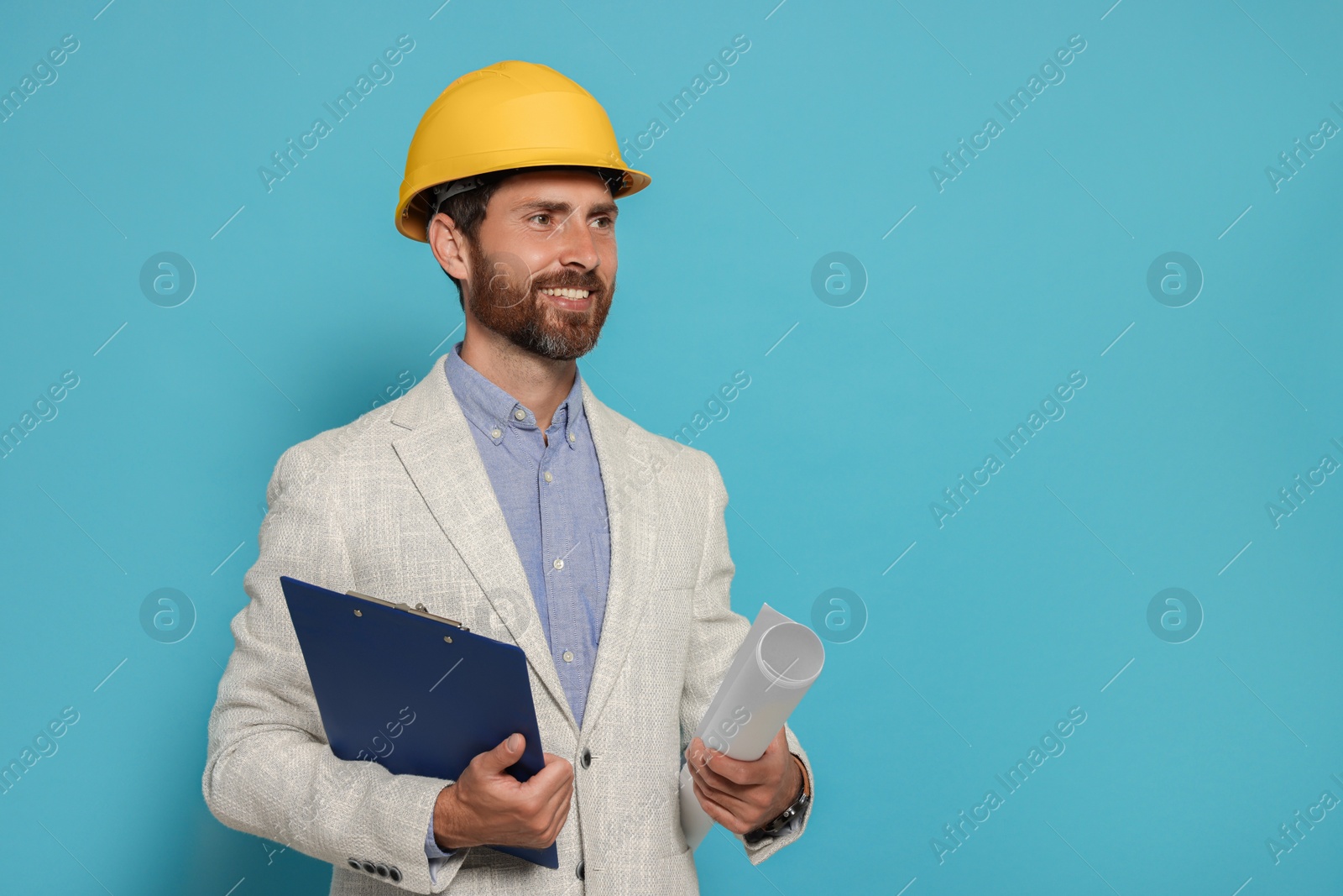 Photo of Professional engineer in hard hat with clipboard and draft on light blue background, space for text