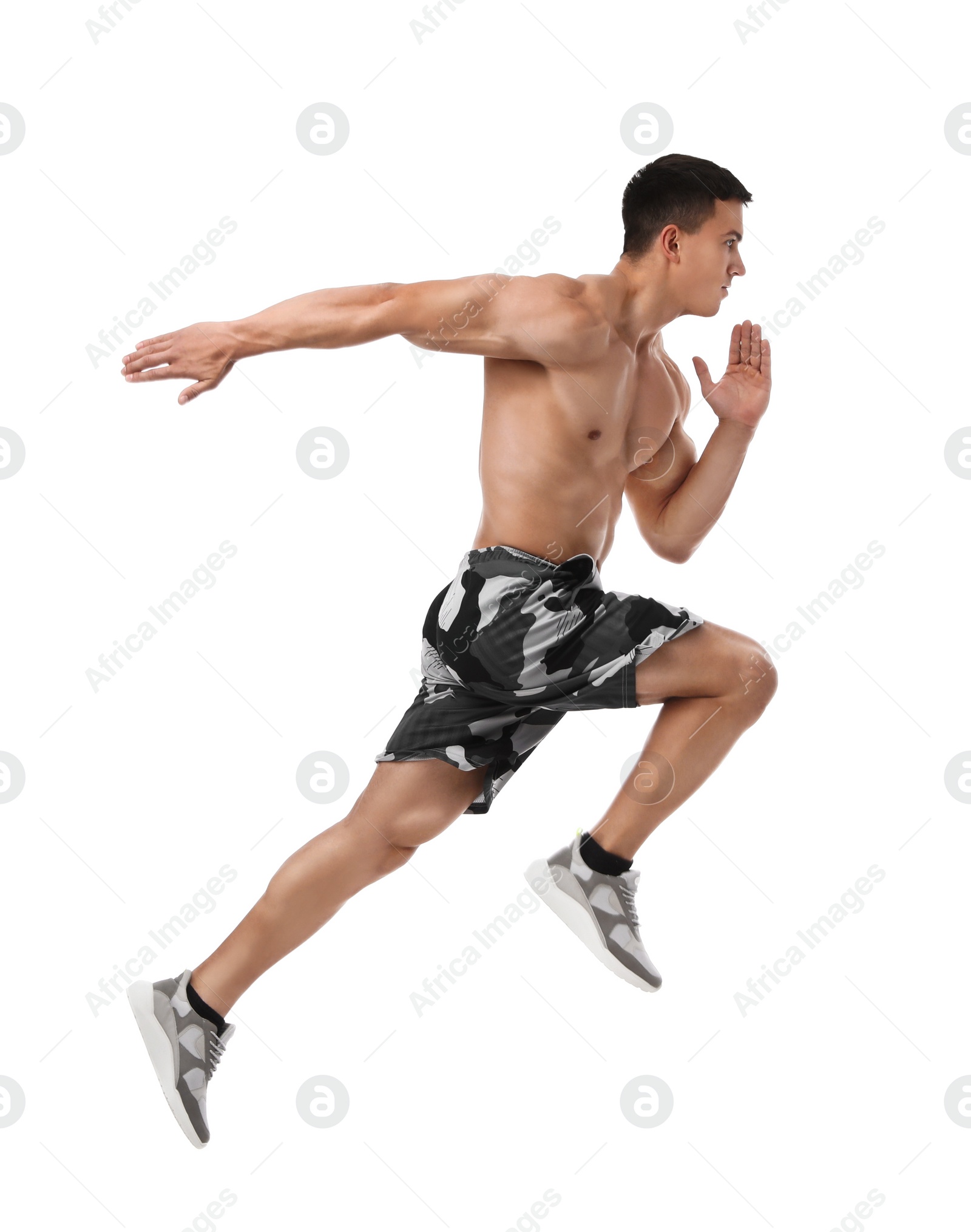 Photo of Athletic young man running on white background, side view