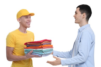 Image of Dry-cleaning delivery. Courier giving folded clothes to man on white background
