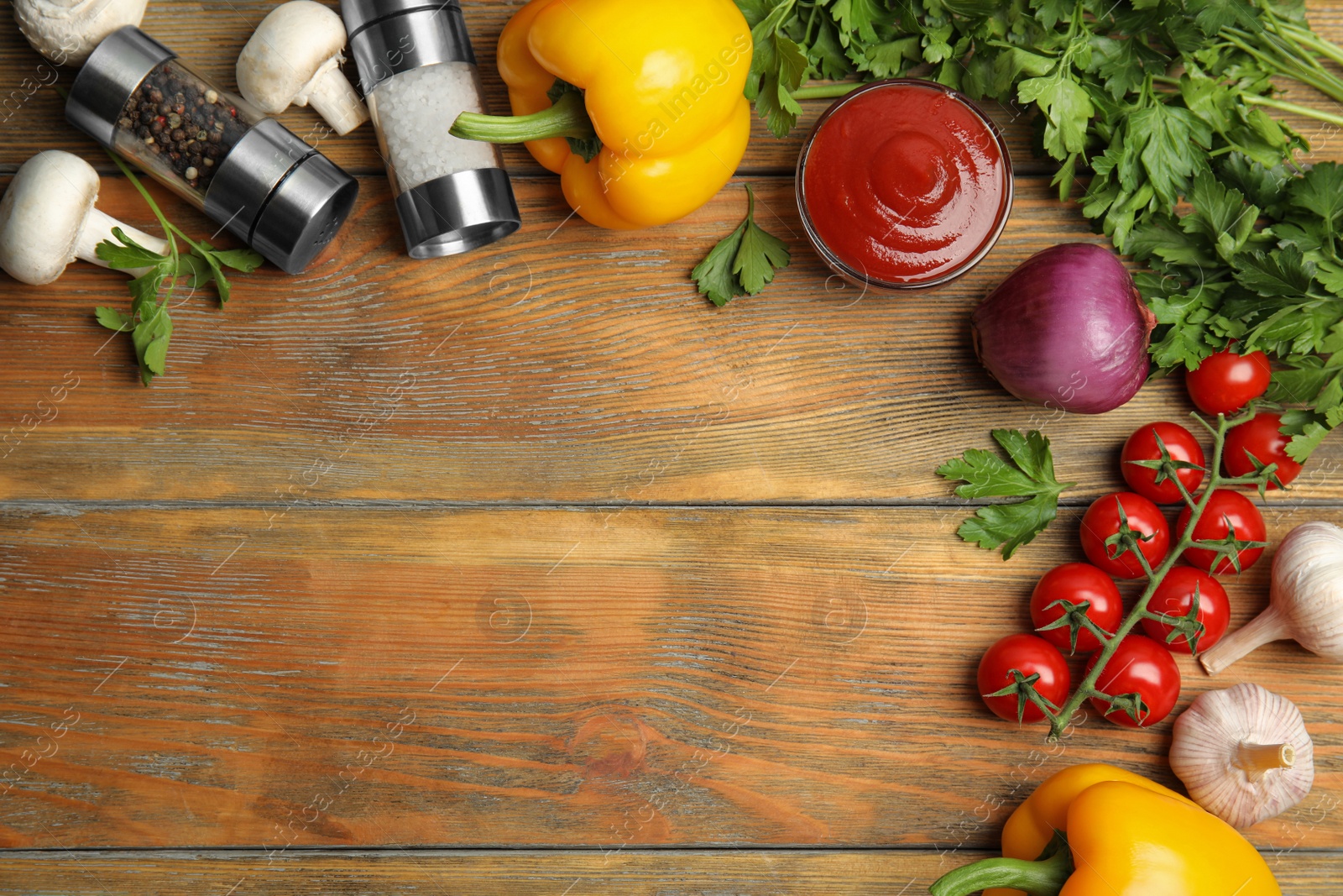 Photo of Flat lay composition with ingredients for cooking on wooden table. Space for text