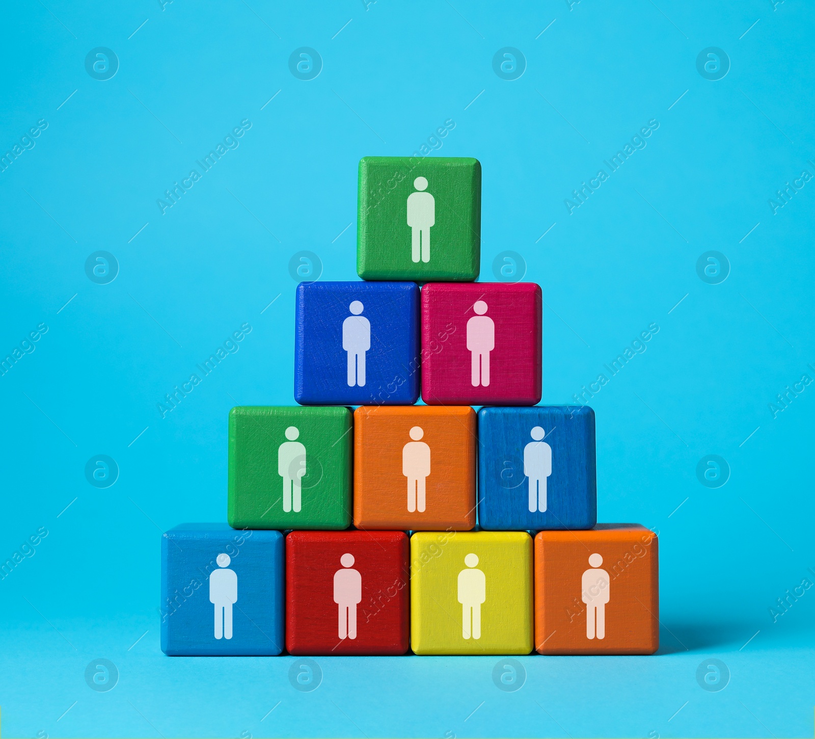 Image of Team and management concept. Pyramid of colorful cubes with human icons on light blue background