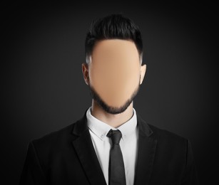 Image of Anonymous. Faceless man in suit on dark background
