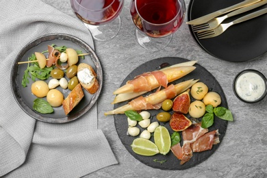 Photo of Flat lay composition with melon and prosciutto appetizer served on table