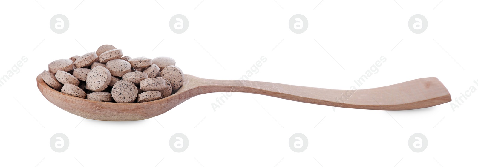 Photo of Brewer's yeast tablets in spoon isolated on white