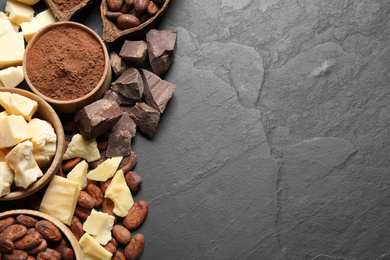 Photo of Flat lay composition with organic cocoa butter on black table. Space for text