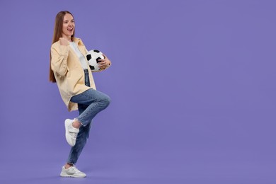 Photo of Emotional sports fan with ball on purple background. Space for text