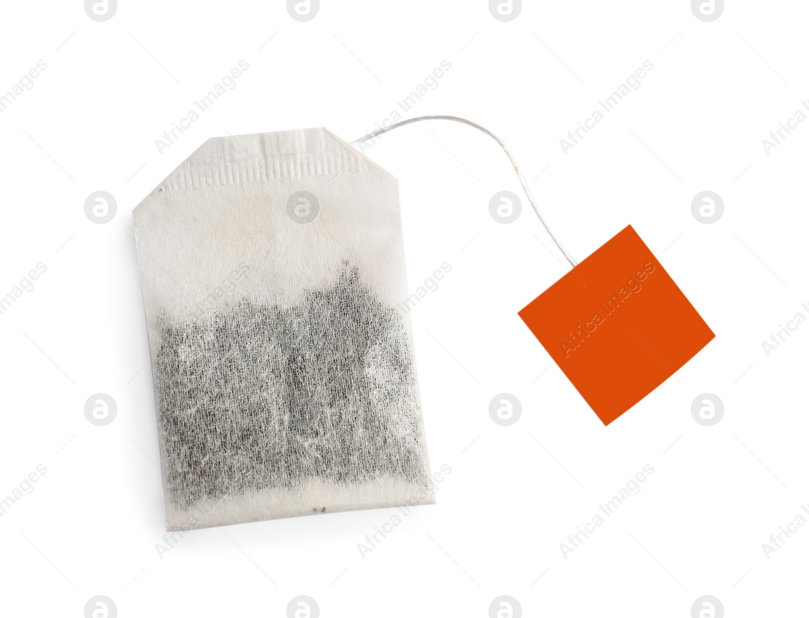 Photo of Paper tea bag with tag isolated on white, top view