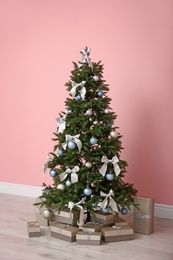 Decorated Christmas tree with gift boxes indoors