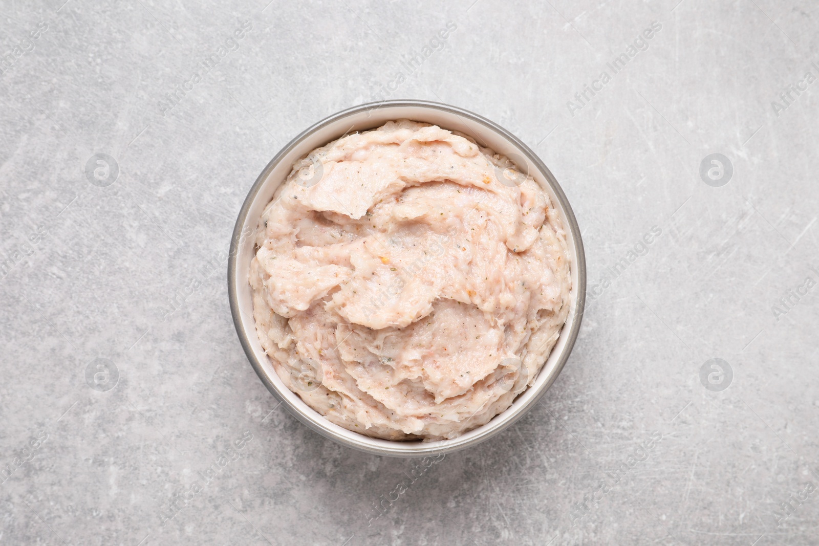 Photo of Delicious lard spread in bowl on light table, top view