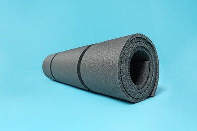 Photo of Grey yoga mat on light blue background