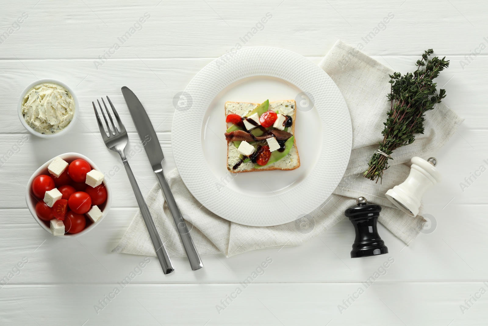 Photo of Flat lay composition with delicious anchovy sandwich on white wooden table