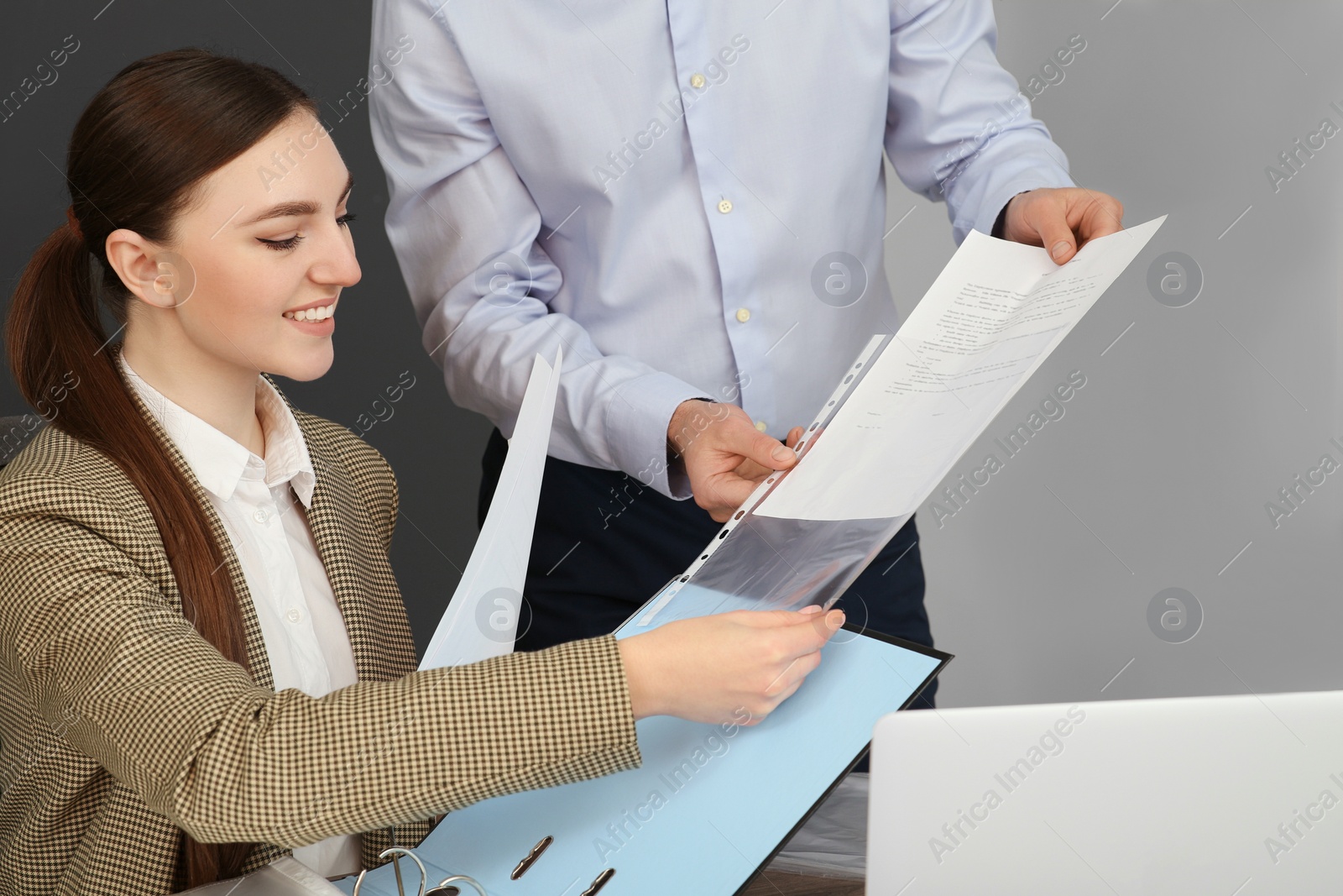 Photo of Businesspeople working together with documents in office