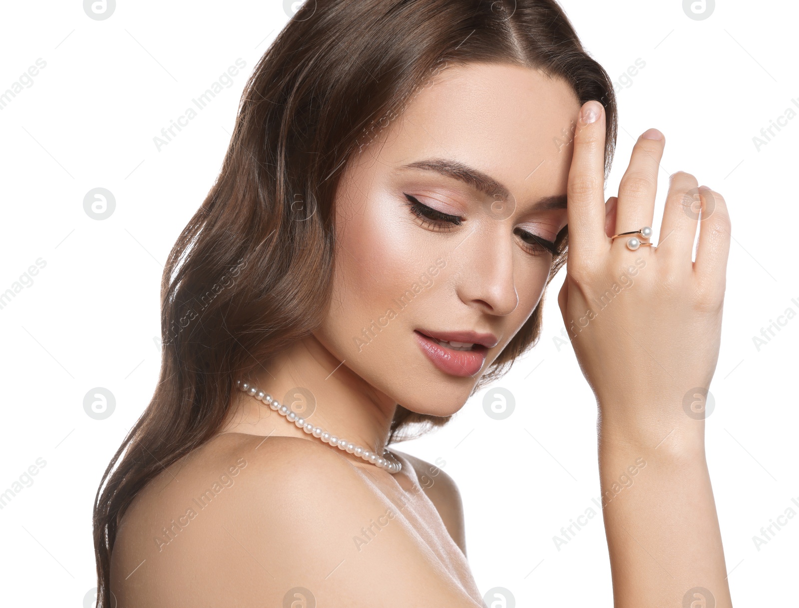 Photo of Young woman with elegant pearl jewelry on white background, closeup