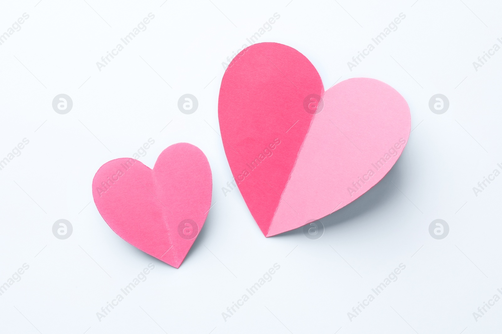 Photo of Pink paper hearts on white background, flat lay