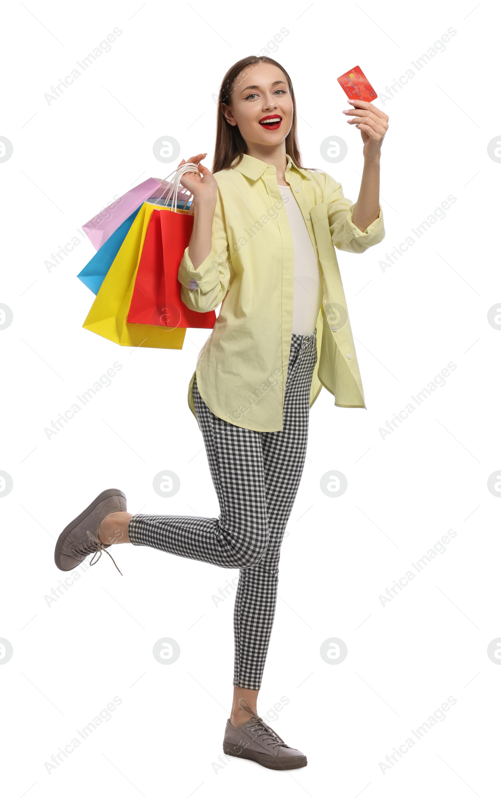 Photo of Stylish young woman with shopping bags and credit card white background