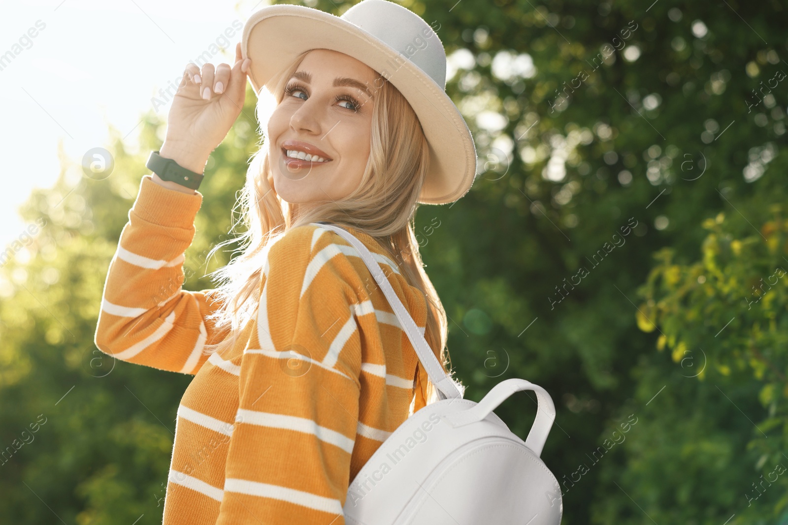 Photo of Portrait of happy young woman in park on spring day