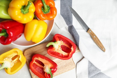 Flat lay composition with ripe bell peppers on table