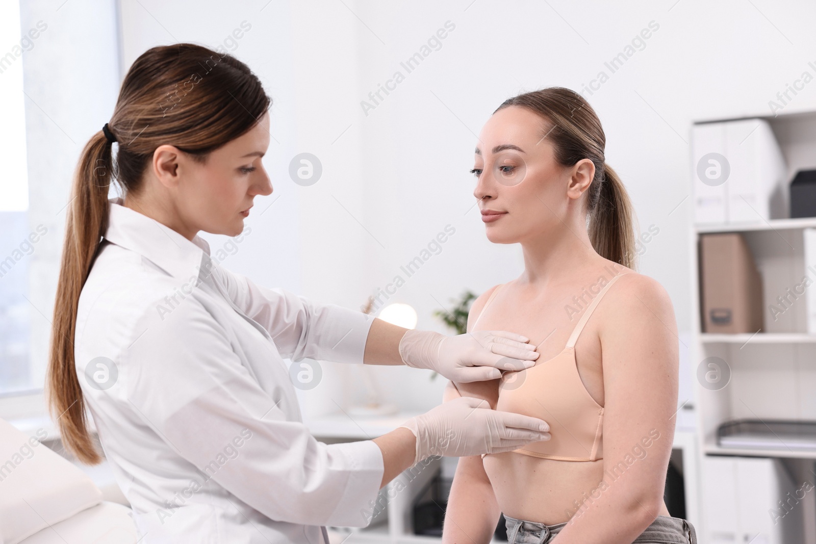 Photo of Mammologist checking young woman's breast in hospital