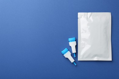 Photo of Disposable express test kit on blue background, flat lay. Space for text