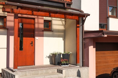 House with wooden door, view from outside. Exterior design