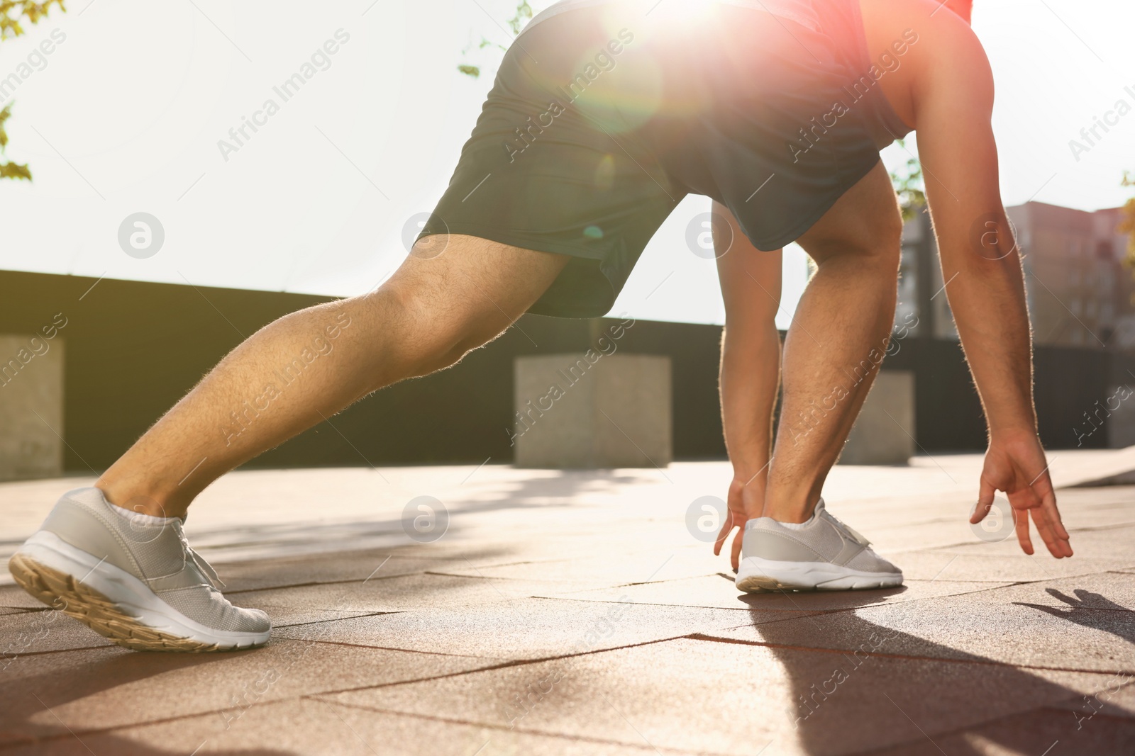 Photo of Runner on starting position outdoors on sunny day closeup