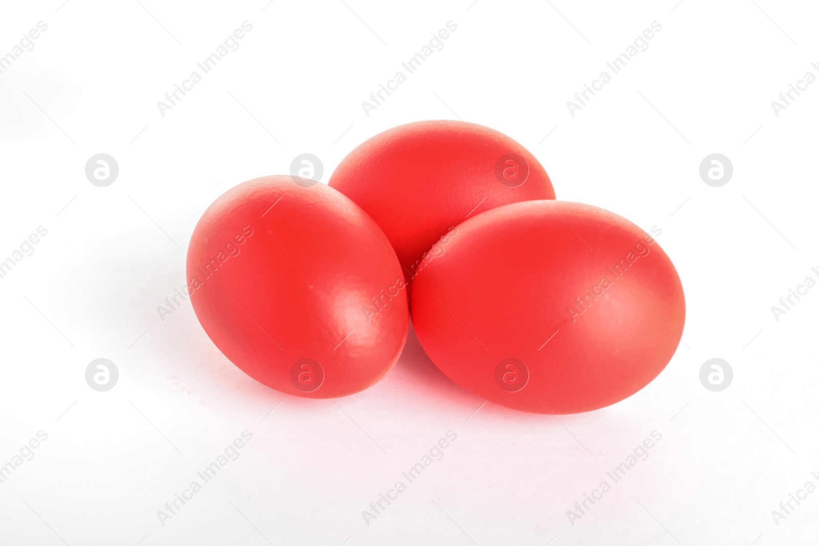 Photo of Red dyed Easter eggs on white background