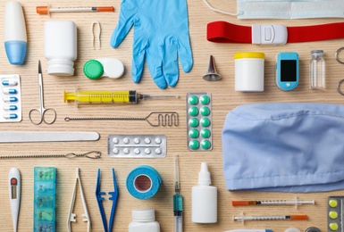 Flat lay composition with medical objects on wooden background