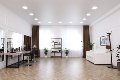 Photo of Stylish beauty salon interior with hairdresser's workplace