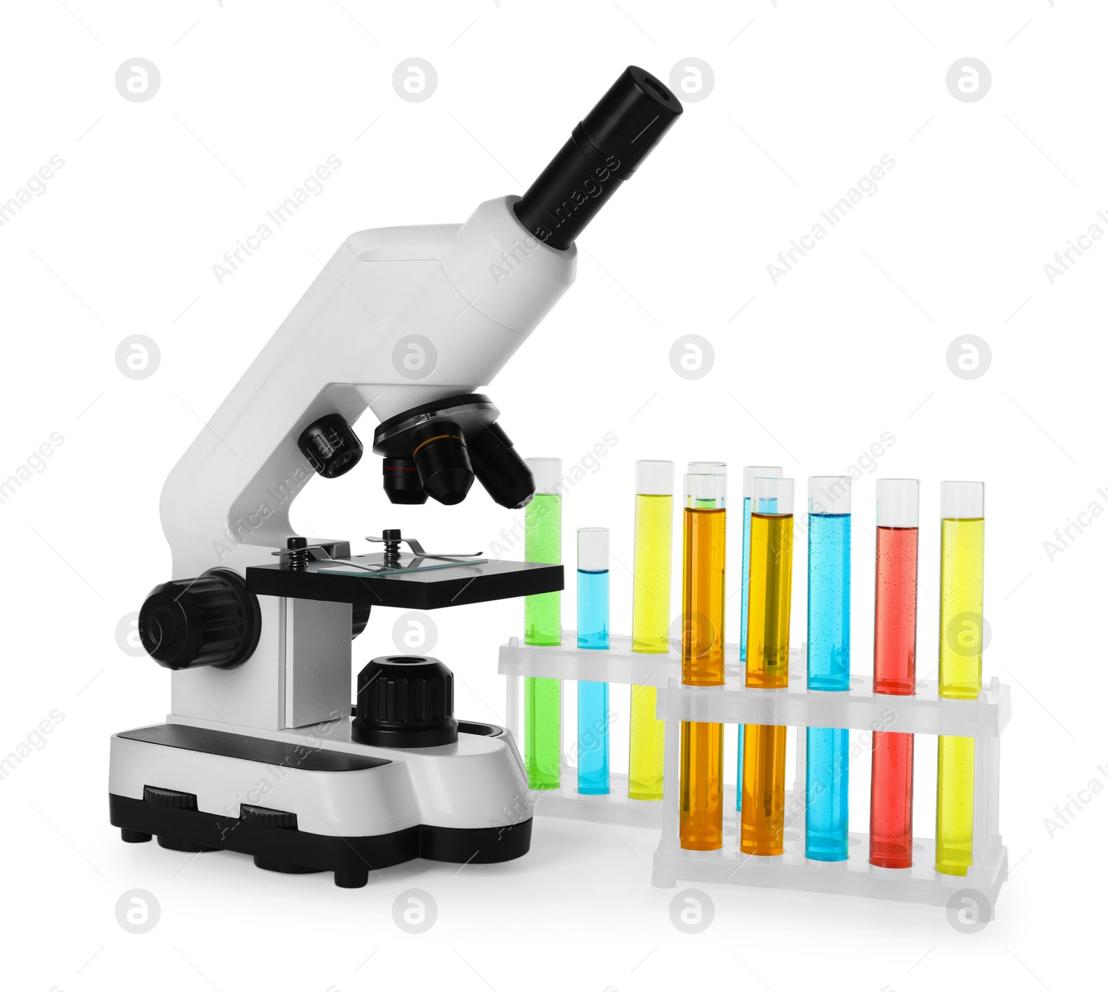 Photo of Test tubes with colorful liquids and microscope isolated on white