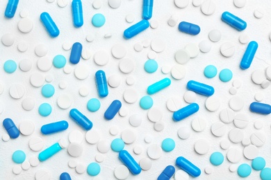 Photo of Pills and capsules on white background, flat lay