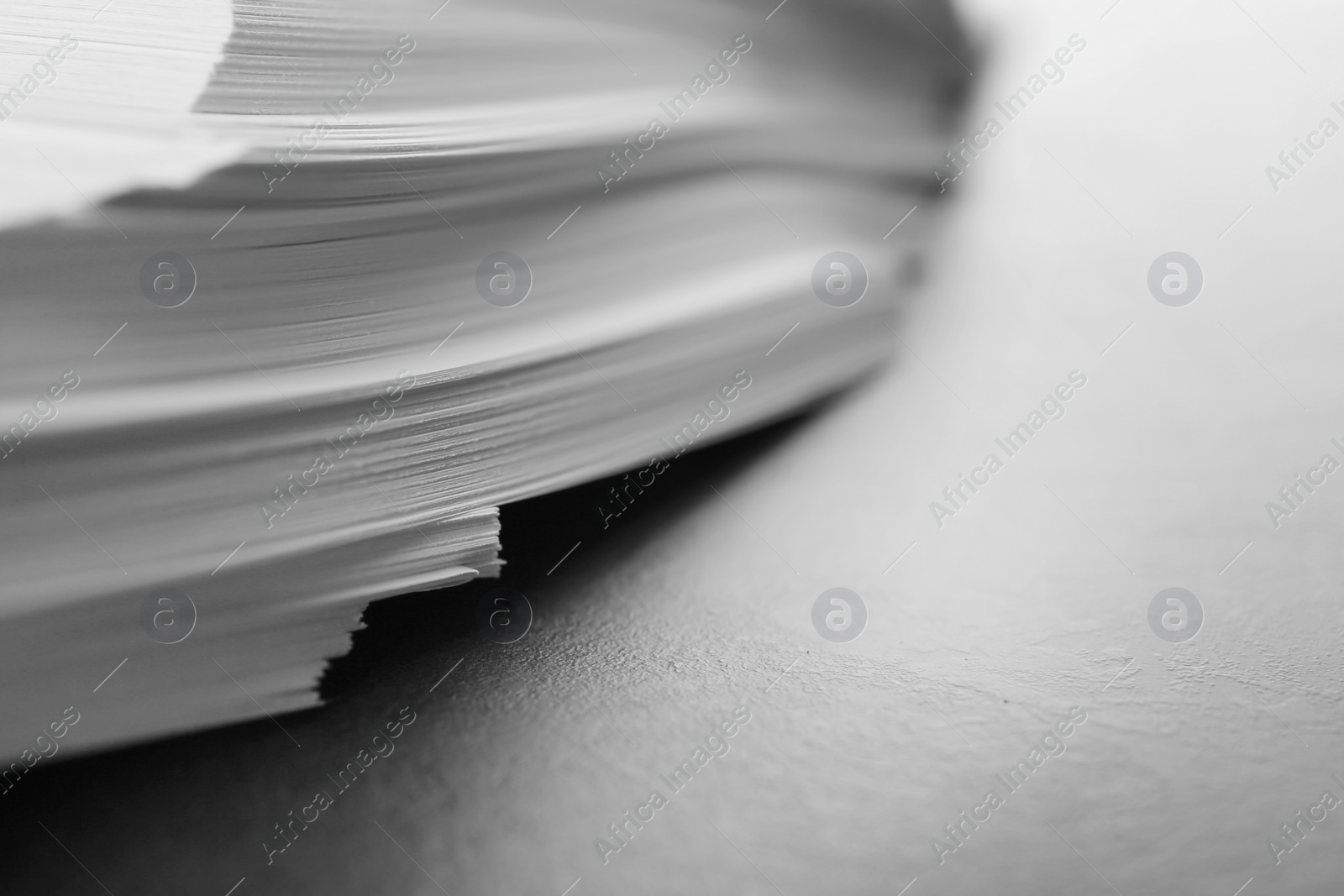 Photo of Stack of blank paper on grey table, closeup