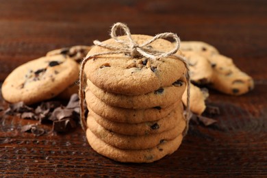 Photo of Delicious chocolate chip cookies on wooden table